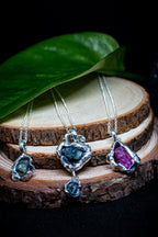 three pendants with raw sapphires and ruby in molten sterling silver